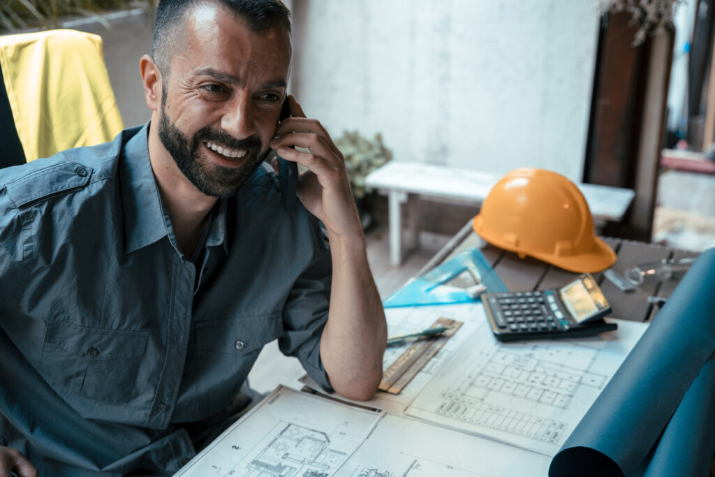 Architect using phone at workplace