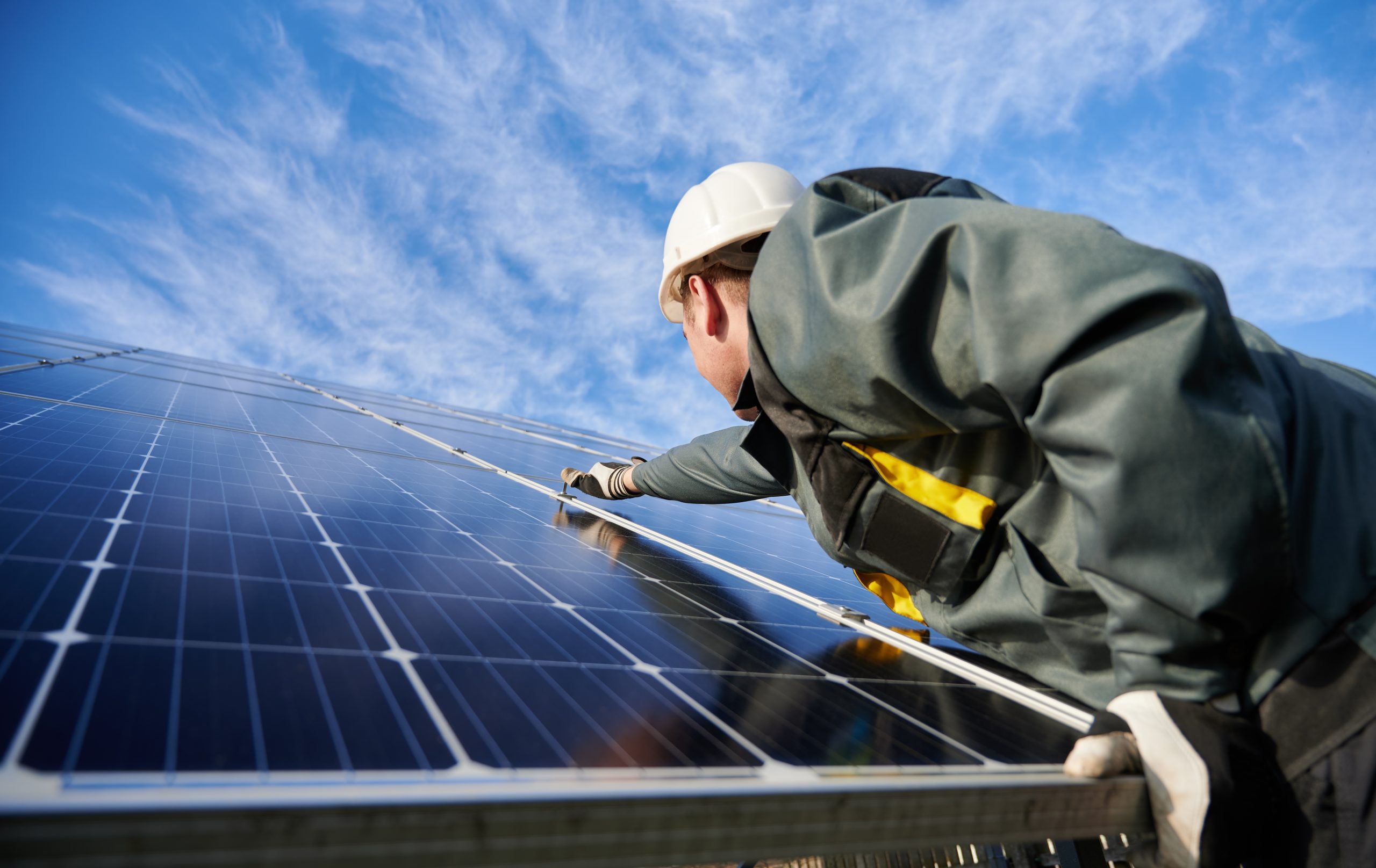 Man cleaning solar panel, United Kingdom
