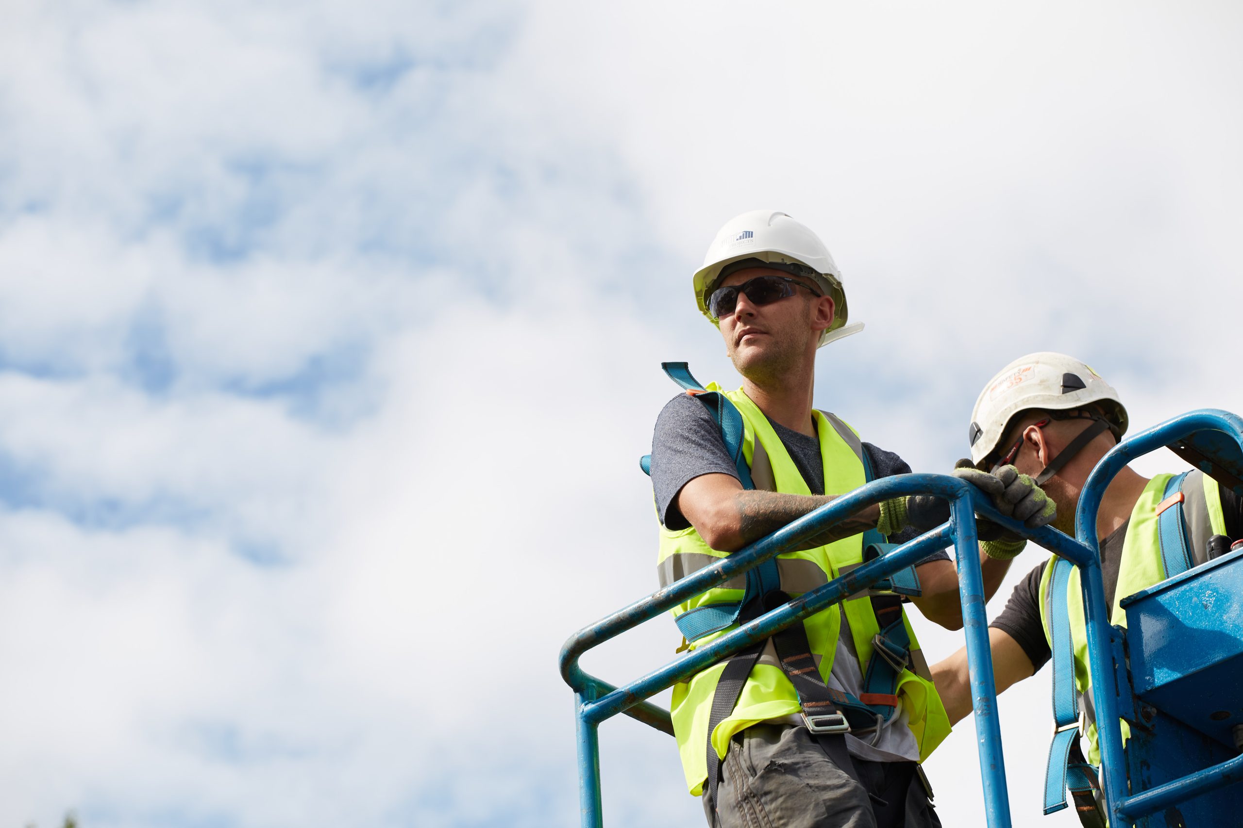 Man on cherry picker wearing high-vis jacket